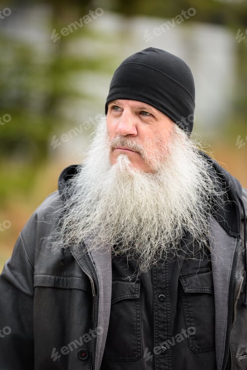 Preview: Face of mature bearded hipster man with hat thinking