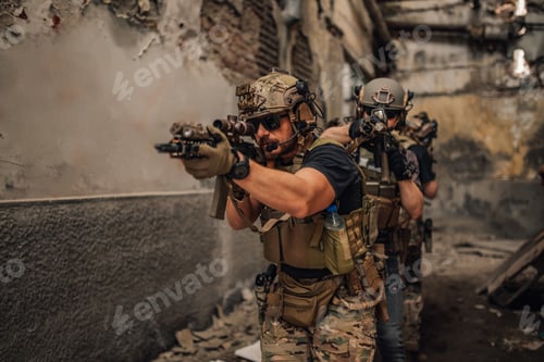 Preview: Group of soldiers with weapons going in mission at abandoned building.