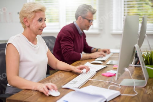 Preview: Co workers busy in front of computers