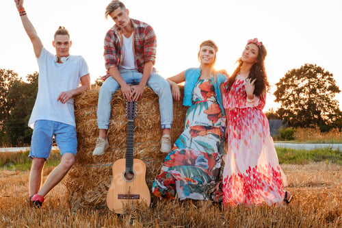 Preview: Hippie friends with guitar in a wheat field