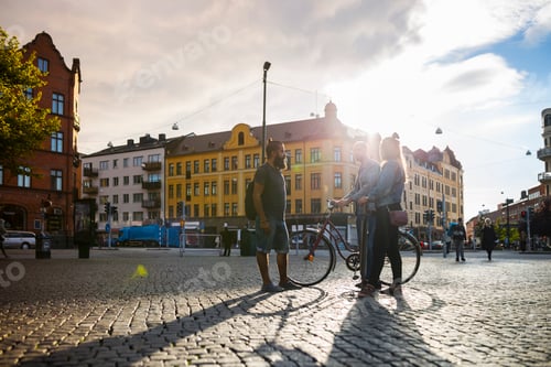 Preview: Three friends standing in town square