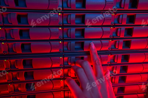 Preview: Female system administrator maintain servers in data center
