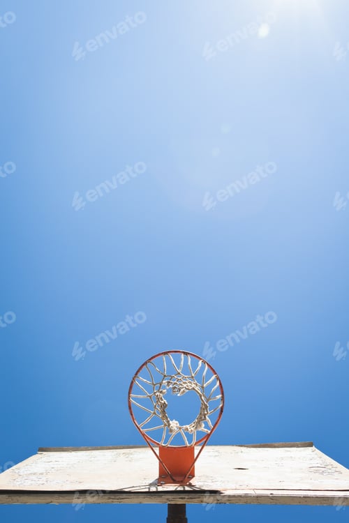 Preview: Basket ball hoop against blue sky