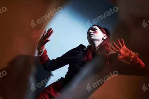 Preview: Caucasian Teen Girl Performing Expressive Mime Art with Dramatic Lighting