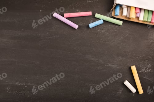 Preview: bright office supplies on black chalkboard top view, copy space.