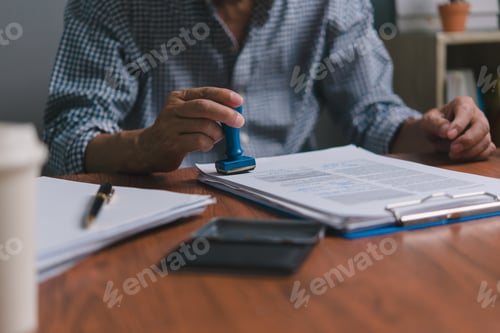 Preview: Hand man stamping documents notary public