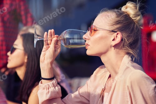 Preview: Charming young woman drinking wine