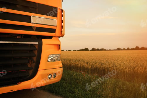 Preview: Modern yellow truck on country road, closeup. Space for text
