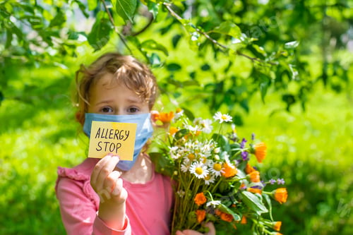 Preview: allergy to flowers in a child. Selective focus.