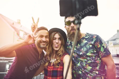 Preview: Man with beard and sunglasses makes bunny ears