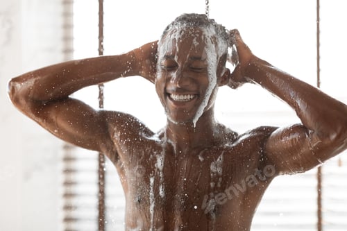 Preview: Happy African Guy Washing Head Taking Shower At Home