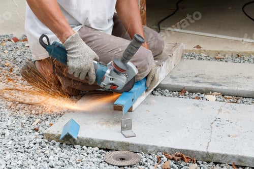 Preview: Closeup shot of a worker cutting a scrap metal with a grinder