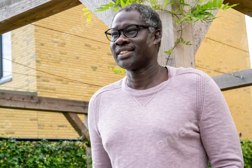 Preview: Nigerian man standing in his garden happy and content