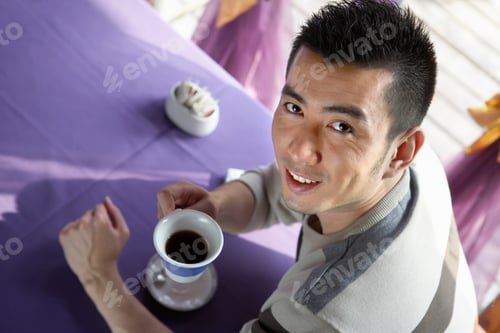 Preview: Man Drinking A Cup Of Coffee