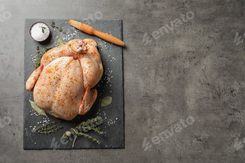 Preview: Slate plate with raw spiced turkey on grey background, top view. Space for text