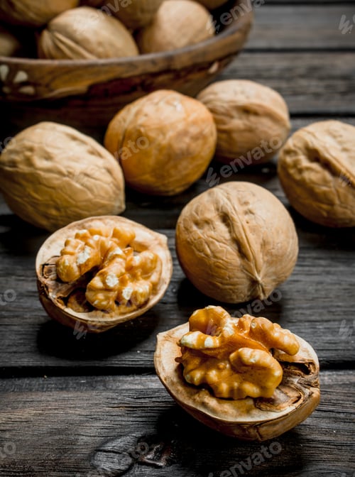 Preview: Peeled walnut on wooden background.