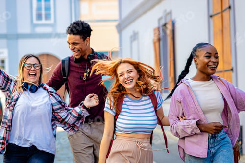 Preview: Excited group of students is walking down the street, overjoyed at the end of their studies.