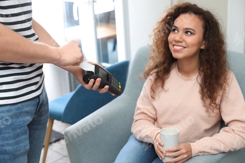 Preview: Client using credit card machine for non cash payment in cafe