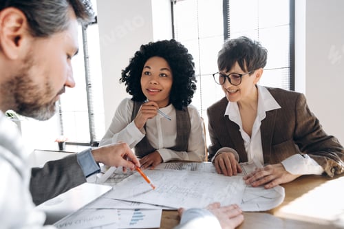 Preview: Architect explaining blueprint to investors during a meeting