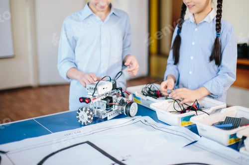 Preview: Two children, brother with sister enaging in their hobby-constructing robot toys