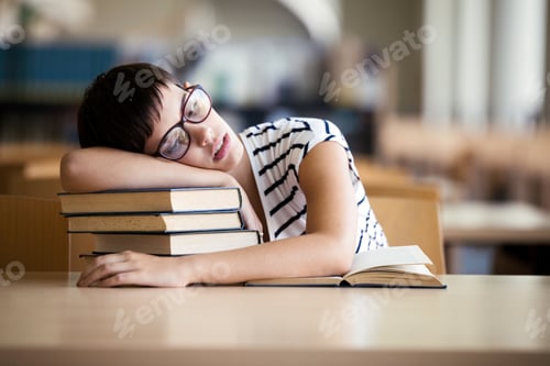 Preview: Tired student girl with glasses sleeping on the books