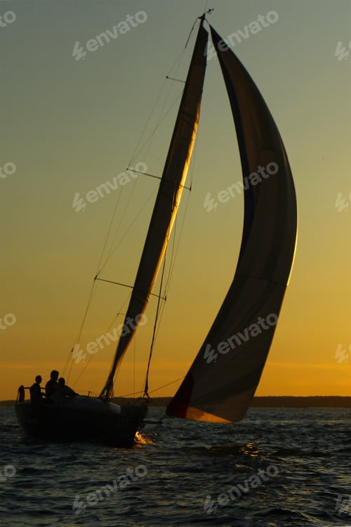 Preview: silhouette of a yacht at sunset. adventure with friends. The concept of travel and yachting