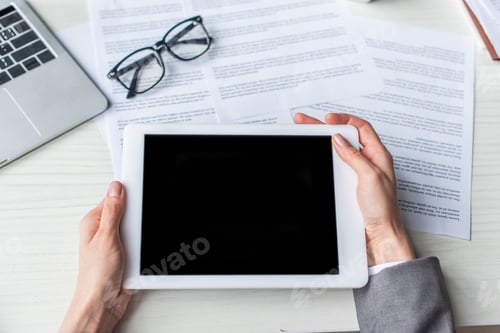 Preview: Cropped view of businesswoman holding digital tablet with blank screen near documents and eyeglasses