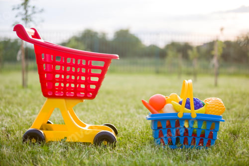 Preview: Shopping pushcart and a basket with toy fruits and vegetables.