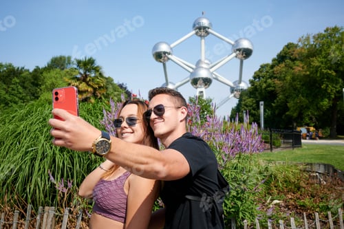 Preview: Young Hispanic couple taking a selfie at Atomium, Brussels, Belgium