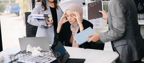 Preview: Stressed Asian Businesswoman Surrounded by Overwhelming Paperwork Concept of Workplace Anxiety
