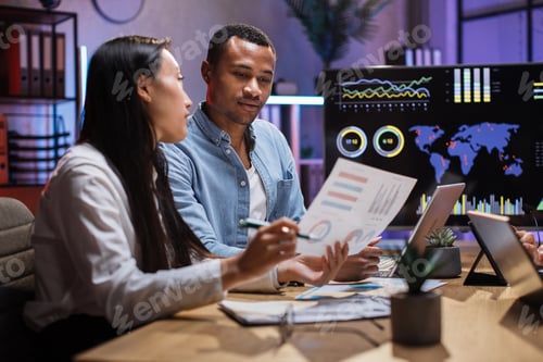 Preview: African man and asian woman having paperwork at office