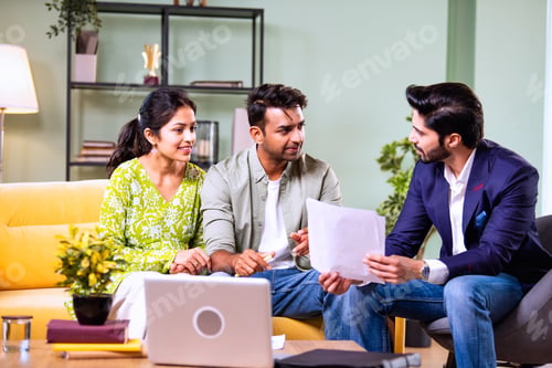 Preview: Indian family investment consultation at home with professional agent reviewing paperwork