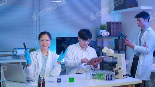 Preview: Smiling female scientist presents results while team records data and examines samples