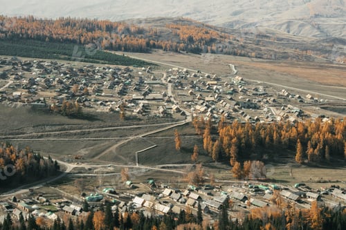 Preview: Aerial view of rural village with autumn trees.