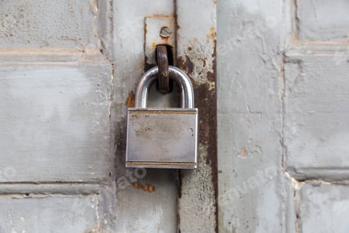 Preview: Old lock on wooden grungy painted door closeup.