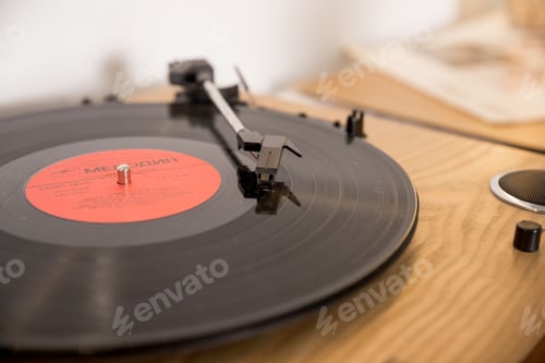 Preview: retro player with vinyl disk on blurred background.Old gramophone turntable with disc.playing vinyl