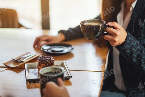 Preview: Closeup image of women enjoyed eating dessert and drinking coffee together in cafe