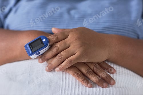 Preview: Close up of patient in hospital with pulse oximeter device on hand