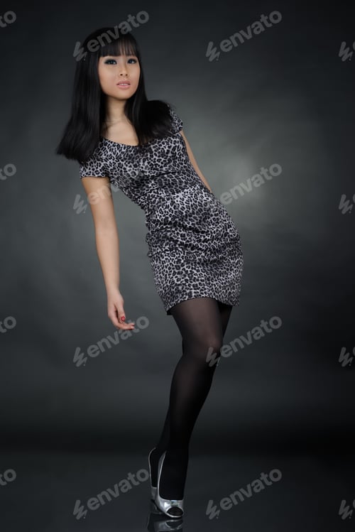 Preview: Small Tiny Asian Woman In Dress At Studio Over Dark Background