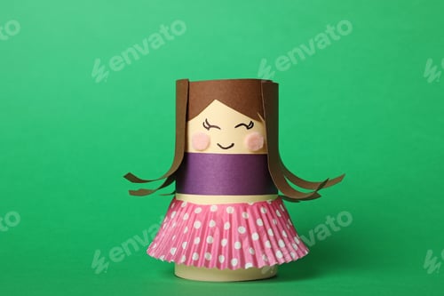 Preview: Toy doll made of toilet paper hub on green background