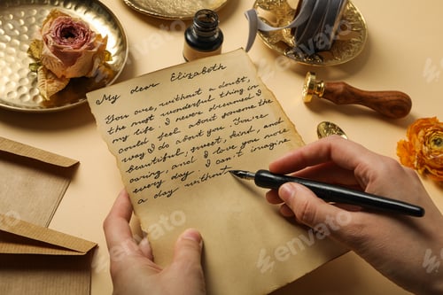 Preview: Letter with text and pen in hands, roses and vintage plates on beige background