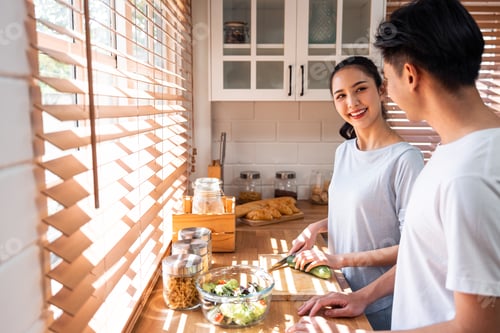 Preview: Asian young new marriage couple spend time together in kitchen at home.