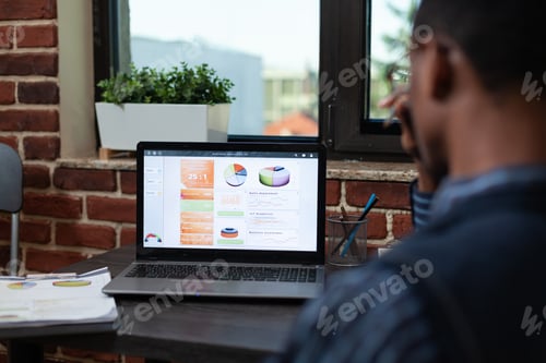 Preview: Close focus on laptop screen showing business sales results charts on desk