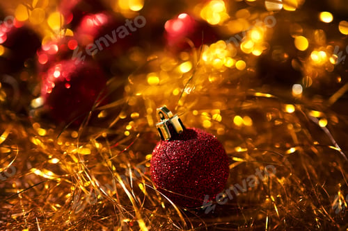 Preview: New Year's balls are red on gold tinsel.