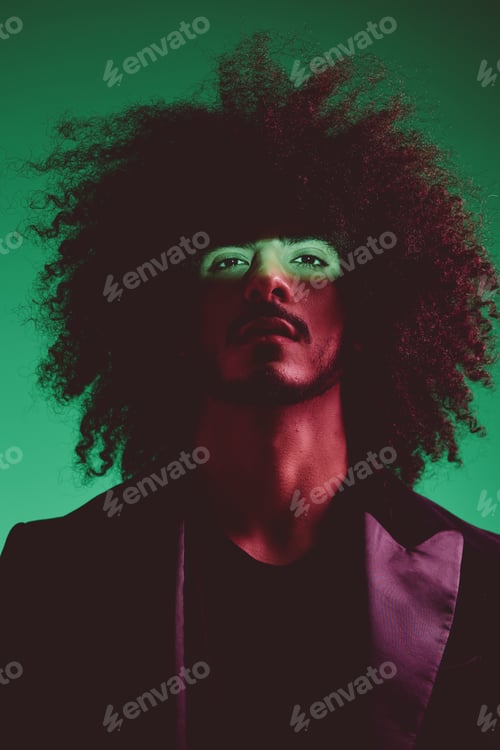 Preview: Portrait of a stylish man in a jacket on a green background multinational, color light, trend