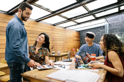 Preview: Four person multiethnic startup discussing ideas in the office