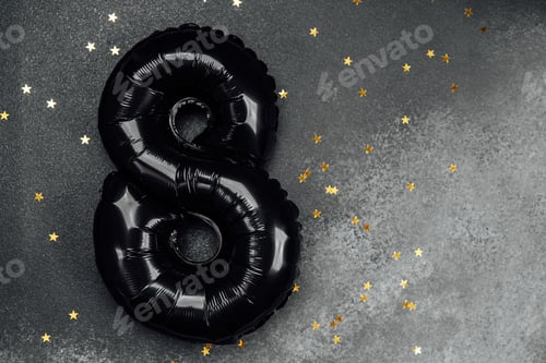 Preview: Black number eight balloon surrounded by golden stars on dark surface