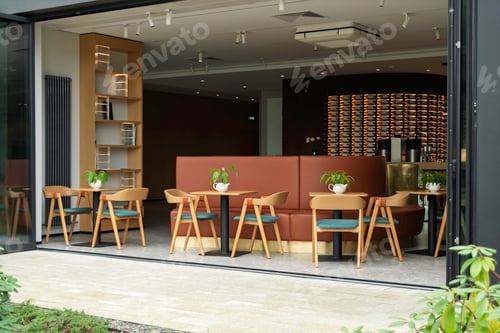 Preview: Modern cafe with open glass walls, stylish furniture, and green plants on tables