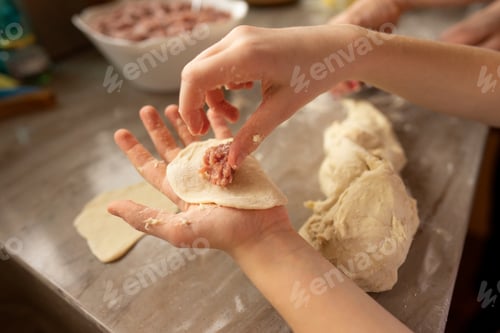 Preview: A young girl cooking home made meat dumplings in the kitchen