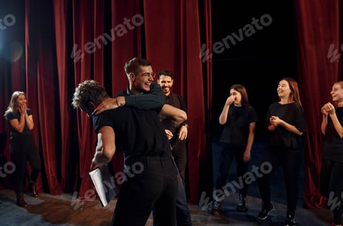 Preview: Fight scene. Group of actors in dark colored clothes on rehearsal in the theater